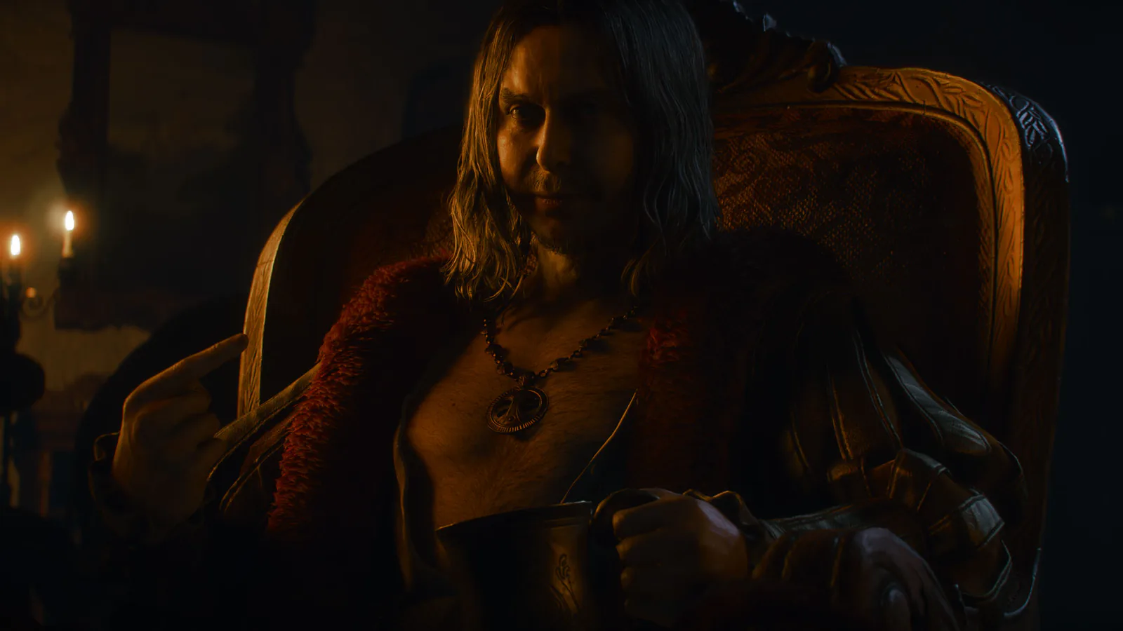 A long-haired man in a fur-trimmed coat sits in a carved chair by candlelight, holding a tankard