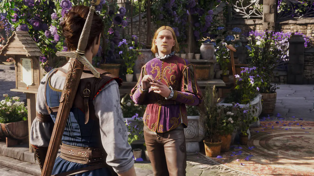The Hero, a sword on her back, talks with a man in a purple doublet in a courtyard full of flowers